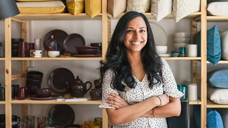 A person smiling with their arms crossed