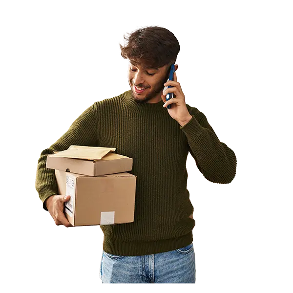 Person holding phone up to ear, while holding boxes.
