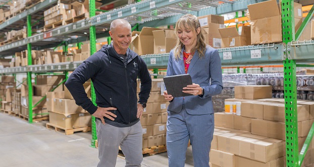 Man and Woman standing in Warehouse