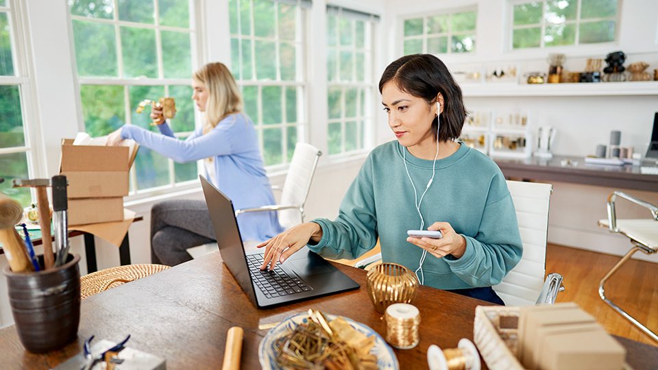 Woman on laptop in small office