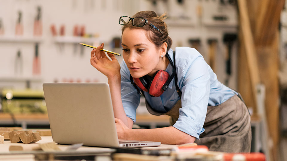 Woman in work studio using laptop