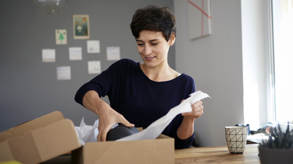 Woman packing a box for UPS
