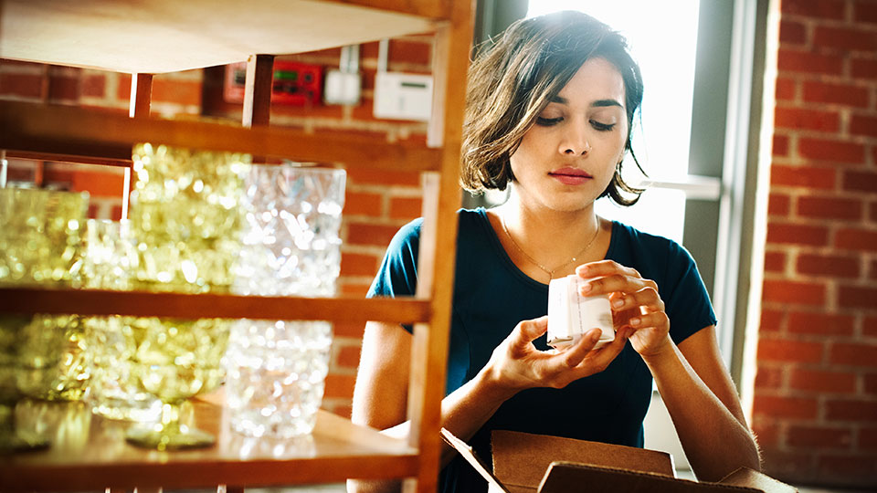 Woman preparing to ship a return package.