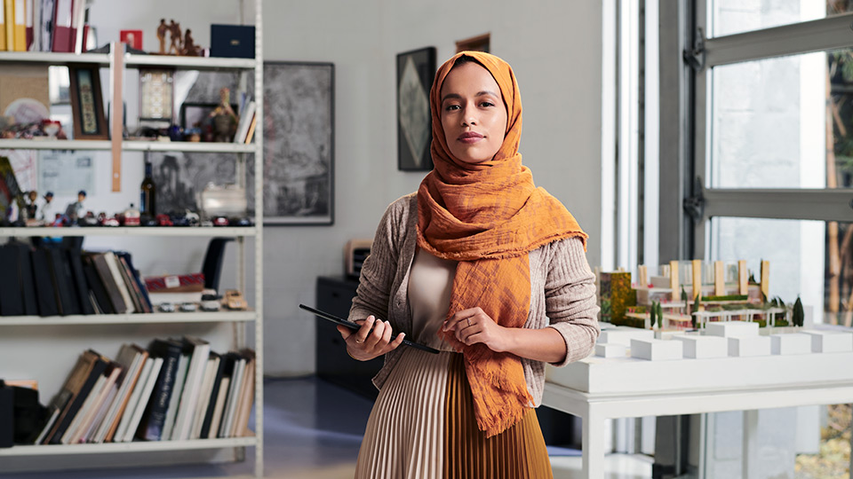 Unstoppable woman in her office with an iPad