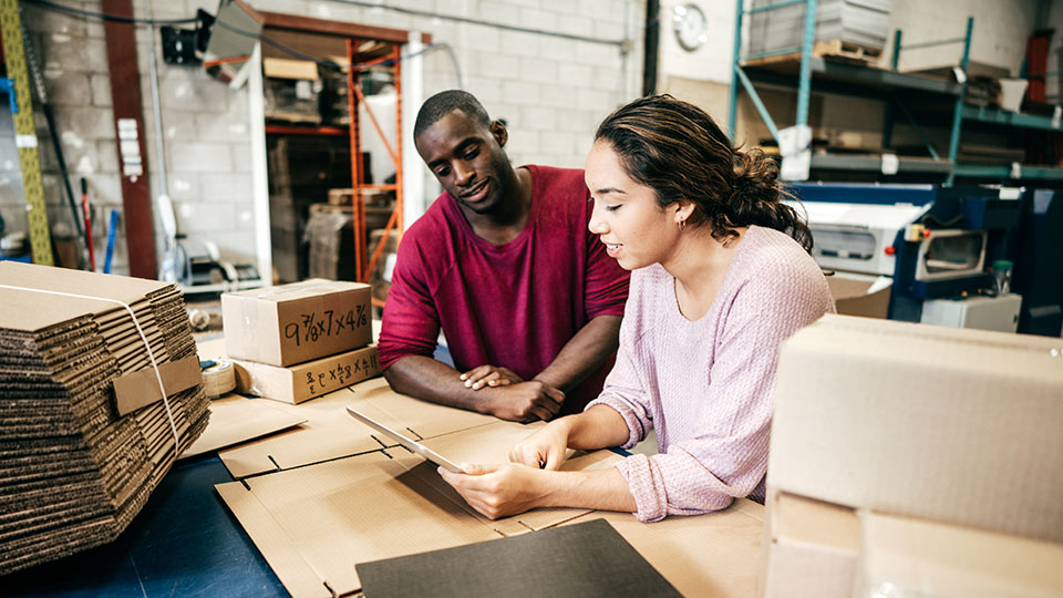 Man and woman using UPS Worldship on tablet